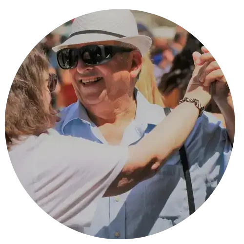 A man in his 60s dancing with a woman